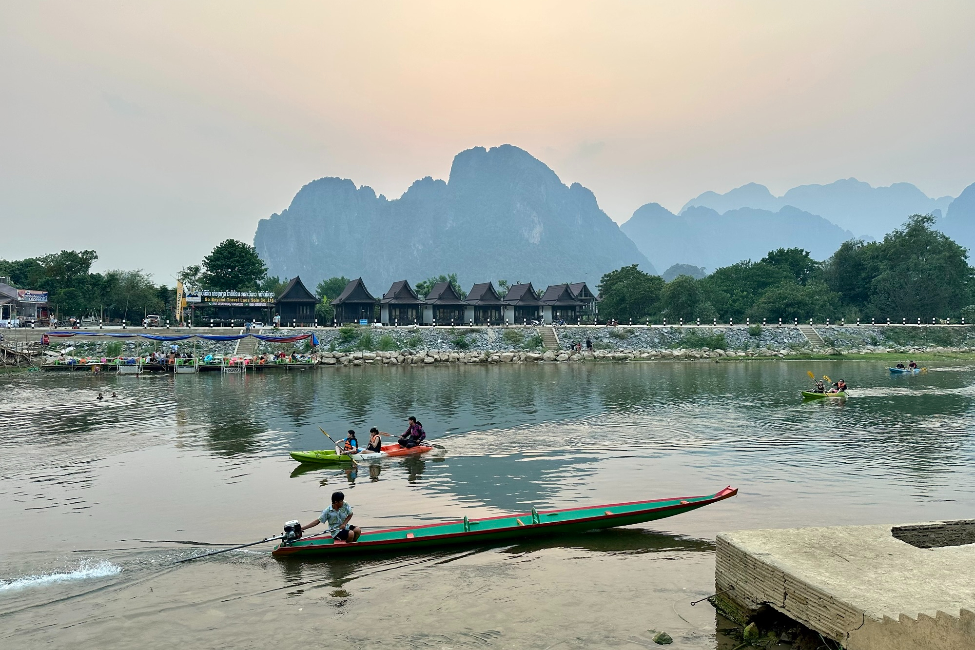 View of a river with boats and karst mountain the background